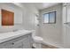 Updated bathroom with gray vanity, shower, and toilet at 17009 E Loyola Pl, Aurora, CO 80013