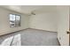 Large bedroom with a window and carpeted floors at 17009 E Loyola Pl, Aurora, CO 80013