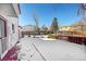 Back deck overlooking a snow-covered backyard at 17009 E Loyola Pl, Aurora, CO 80013