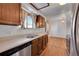 Kitchen with wood cabinets, a double sink, and hardwood floors at 17009 E Loyola Pl, Aurora, CO 80013