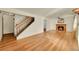 Living room with hardwood floors, a fireplace, and a staircase at 17009 E Loyola Pl, Aurora, CO 80013