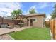 Landscaped backyard featuring a pergola, outdoor furniture, fire pit, and artificial grass at 4511 Perry St, Denver, CO 80212