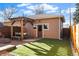 A backyard patio featuring a pergola, artificial grass, and a firepit at 4511 Perry St, Denver, CO 80212