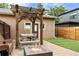 Backyard featuring a pergola with lights, seating, fire pit, and artificial grass at 4511 Perry St, Denver, CO 80212