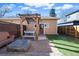 Backyard patio area with pergola over a patio table, artificial grass, and a fire pit at 4511 Perry St, Denver, CO 80212