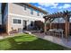 A backyard featuring a patio, pergola, artificial grass, and an outdoor grill at 4511 Perry St, Denver, CO 80212