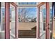 View of the exterior from a balcony with wooden floors and a red door frame at 4511 Perry St, Denver, CO 80212