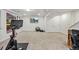 Open concept basement with exercise equipment, a TV, and adjacent to a home office area at 4511 Perry St, Denver, CO 80212