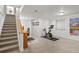 Spacious basement with staircase, exercise bike, and a home office area at 4511 Perry St, Denver, CO 80212