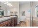 Bathroom featuring double sinks, granite countertops, vanity, bathtub and separate glass enclosed shower at 4511 Perry St, Denver, CO 80212