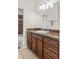 Well-lit bathroom featuring a vanity with granite top and a large mirror at 4511 Perry St, Denver, CO 80212