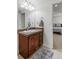 Bright bathroom with modern vanity, granite countertop, and a large mirror at 4511 Perry St, Denver, CO 80212