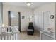 Bedroom featuring a chair, ottoman, crib, dresser, and closet with carpet at 4511 Perry St, Denver, CO 80212