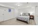 Cozy carpeted bedroom with white walls, recessed lights, and a comfortable queen-sized bed at 4511 Perry St, Denver, CO 80212