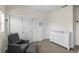 Comfortable Bedroom featuring a gray chair, white dresser, and closet with sliding doors at 4511 Perry St, Denver, CO 80212