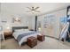 Bright bedroom featuring a ceiling fan, large windows, and elegant decor with hardwood floors at 4511 Perry St, Denver, CO 80212