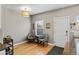 Cozy dining area featuring hardwood floors, comfortable chairs, and a view through a window at 4511 Perry St, Denver, CO 80212