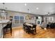 Open concept dining area with modern lighting and hardwood floors, adjacent to the living room at 4511 Perry St, Denver, CO 80212