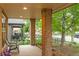 Inviting covered front porch with brick pillars and seating area at 4511 Perry St, Denver, CO 80212