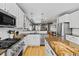 A kitchen with stainless steel appliances, white cabinets, granite countertops, and hardwood floors at 4511 Perry St, Denver, CO 80212