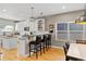 Modern kitchen featuring white cabinets, granite countertops, and stainless steel appliances at 4511 Perry St, Denver, CO 80212