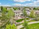 This aerial view showcases the home's large backyard, deck, and patio with great landscaping at 2605 Gray Wolf Loop, Broomfield, CO 80023