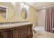 Bathroom with double sinks, granite countertops, and tile shower at 2605 Gray Wolf Loop, Broomfield, CO 80023