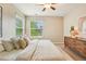 Relaxing bedroom featuring neutral tones, a large window, and a cozy bed at 2605 Gray Wolf Loop, Broomfield, CO 80023