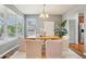 Bright dining room with a modern chandelier, large windows, and seating for six at 2605 Gray Wolf Loop, Broomfield, CO 80023