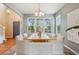 Bright dining room with a modern chandelier, large windows, and seating for six at 2605 Gray Wolf Loop, Broomfield, CO 80023