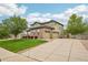 Spacious three-car garage, long concrete driveway, and manicured lawn of this beautiful home at 2605 Gray Wolf Loop, Broomfield, CO 80023