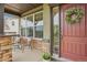 Charming front door with wreath, seating area and natural light at 2605 Gray Wolf Loop, Broomfield, CO 80023