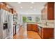 Kitchen features stainless steel appliances, wooden cabinets, and hardwood floors at 2605 Gray Wolf Loop, Broomfield, CO 80023