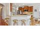 Kitchen bar with seating, stainless steel appliances, hardwood floors, and modern countertops at 2605 Gray Wolf Loop, Broomfield, CO 80023