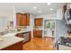 Open kitchen with hardwood floors, stainless steel appliances, and access to the dining room at 2605 Gray Wolf Loop, Broomfield, CO 80023