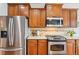 Kitchen features stainless steel appliances, hardwood floors, and wood cabinets at 2605 Gray Wolf Loop, Broomfield, CO 80023