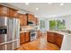 Well-lit kitchen with stainless steel appliances, hardwood floors, and a view to the backyard at 2605 Gray Wolf Loop, Broomfield, CO 80023