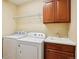 Well-equipped laundry room featuring a washer, dryer, sink, and ample cabinet space for storage at 2605 Gray Wolf Loop, Broomfield, CO 80023