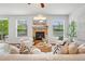 Bright living room with a stone fireplace, hardwood floors, and comfortable seating at 2605 Gray Wolf Loop, Broomfield, CO 80023