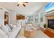 Bright, open living room with hardwood floors, fireplace, and access to the kitchen and dining area at 2605 Gray Wolf Loop, Broomfield, CO 80023