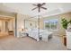 Spacious main bedroom with a four-poster bed, tray ceilings, and bright windows at 2605 Gray Wolf Loop, Broomfield, CO 80023