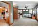 Cozy bedroom and bath suite featuring carpet floors and a ceiling fan at 2624 Kalmia Ave, Boulder, CO 80304