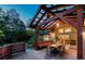 Evening shot of deck with covered dining area, outdoor furniture, and view into the living room at 2624 Kalmia Ave, Boulder, CO 80304