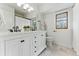 Bright bathroom features dual sink vanity, marble countertop, updated fixtures, and a window at 2011 S Gray Dr, Lakewood, CO 80227