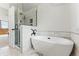 Modern bathroom with a soaking tub, glass-enclosed shower, and elegant tile work for a spa-like experience at 2011 S Gray Dr, Lakewood, CO 80227