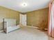 Comfortable bedroom space featuring a crib, rocking chair, and neutral carpet at 2011 S Gray Dr, Lakewood, CO 80227