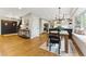 Open-concept dining area featuring hardwood floors, modern lighting, and window bench at 2011 S Gray Dr, Lakewood, CO 80227