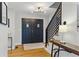 Inviting entryway with hardwood floors, modern lighting, and a stylish staircase with black banister at 2011 S Gray Dr, Lakewood, CO 80227