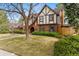 Charming Tudor-style home featuring a well-manicured front lawn and mature landscaping at 2011 S Gray Dr, Lakewood, CO 80227