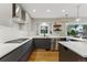 Modern kitchen with stainless steel appliances, sleek white countertops, and ample counter space at 2011 S Gray Dr, Lakewood, CO 80227